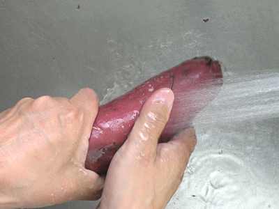 材料のサツマイモを洗っています